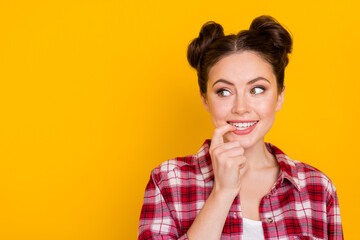 Wall Mural - Portrait of cheerful pretty girl bite finger nail look interested empty space isolated on yellow color background