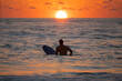 Silhouette of Surfer waiting on the line up for a wave at sunrise or sunset