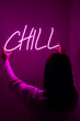 Beautiful girl with neon signs. Pink neon sign chill. Trendy style. Neon sign. Custom neon. Home decor. 