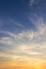 Wall Mural - sunset sky clouds vertical in the evening on summer season with orange, yellow, sunlight on blue sky