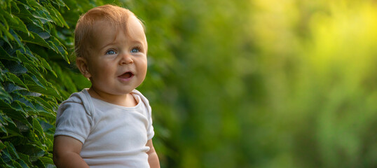 Little happy baby on green grass. selective focus