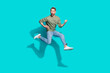 © deagreez - Full length profile photo of inspired sportsman jump play imaginary guitar wear pullover isolated blue color background