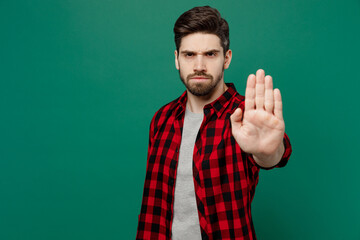 Poster - Young sad strict serious caucasian man he 20s wearing red shirt grey t-shirt look camera show stop gesture with palm isolated on plain dark green background studio portrait People lifestyle concept