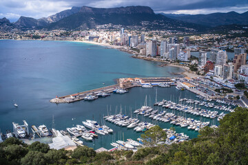 view from above of a small port in the Mediterranean Sea and hotels with mountains in the background Calpe city