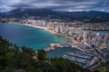 view from above of a small port in the Mediterranean Sea and hotels with mountains in the background Calpe city