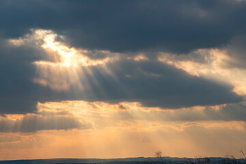 Wall Mural - beautiful sun rays from stormy clouds