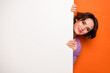 © deagreez - Photo of pretty shy girl dressed purple pullover hiding white placard empty space isolated orange color background