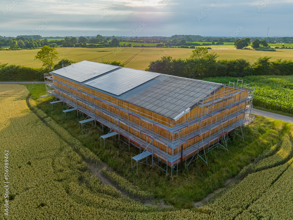 Solar panels on farm barn. Agriculture barn under renovation works with ...