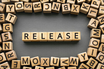 Inscription Release software development concept. Wooden cubes with letters scattered blurred background