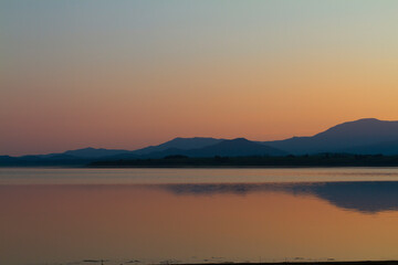 Wall Mural - Lake at sunset blue hour. Wetland and Mountain landscape.