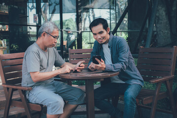 Asian family chatting while using smartphone