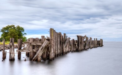  Old wooden pylons in water remains of railway ferry dock at Prescott Ontario