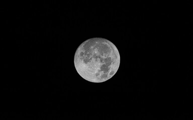 Wall Mural - beautiful full moon isolated in the middle of black sky