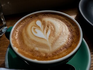 Sticker - Closeup of a cup of coffee with foam art.