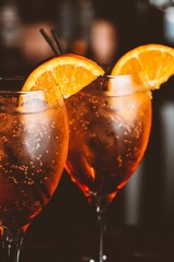 Poster - Vertical closeup of two glasses of Aperol Spritz on bar counter