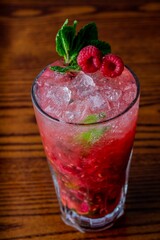 Sticker - Vertical closeup of Raspberry mojito on wooden table