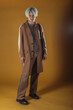 © qunica.com - Portrait of a smart young man standing against yellow backgroun