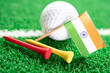 Golf ball with India flag and tee on green lawn or grass is most popular sport in the world.