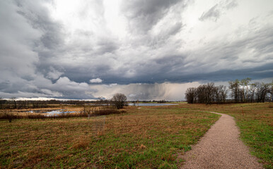 Wall Mural - Rain falls across the lake on a spring day