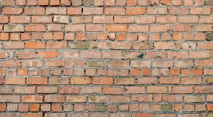 Wall Mural - Texture of a weathered, crumbling old red brick industrial building wall.