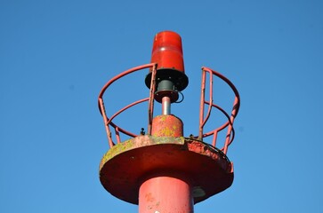 Sticker - Tower with a red lamp against the blue sky.