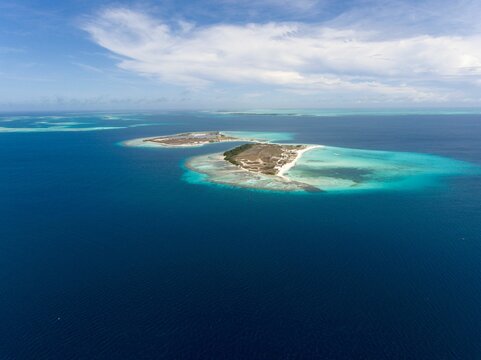 Aerial view of an island in Los Roques in Venezuela surrounded by clear seawater