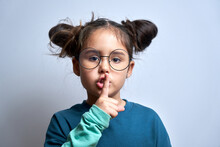 Shh Little Brunette Girl Asks To Keep Silence And Secret Isolated On White Background