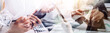 © ARMMY PICCA - Business accountant working on desk using mobile phone and calculator to calculate budget concept finance and accounting in morning light
