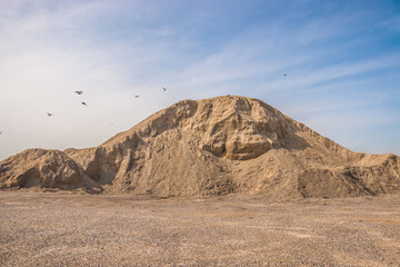 A stockpile of inert building materials. A large pile of sand and gravel. High resolution photo.