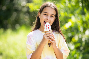 Wall Mural - Beautiful little girl eats ice-cream in the summer