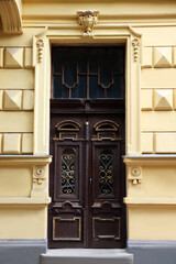 Wall Mural - Entrance of house with beautiful wooden door, elegant moldings and transom window