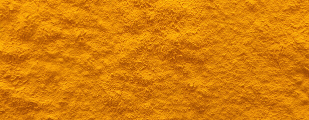 Aromatic turmeric powder as background, top view