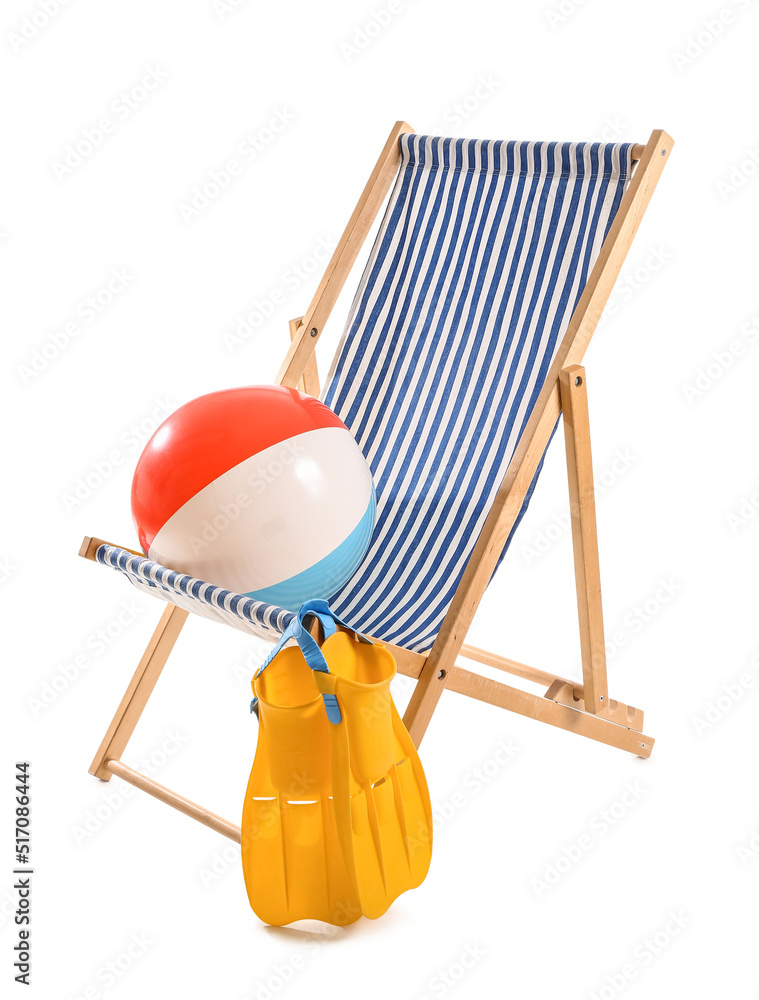 Striped deck chair with paddles and ball on white background