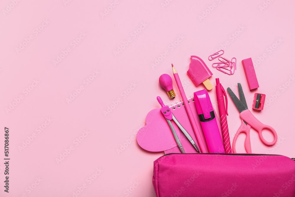 Pencil case with stationery supplies on pink background