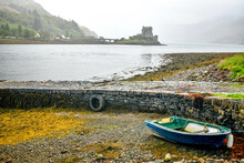 Fishing Boat At Low Tide With Eilean Donan Castle In The Background