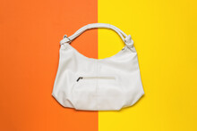 A Large Beautiful White Leather Women's Bag On A Yellow And Orange Background. Women's Accessory.