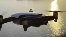 Small four-engine drone captures the sea at sunset