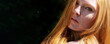 © ullision - closeup wide banner portrait of beautiful redhead woman, in the summer sun, looking seductively sensual over her shoulder on the side of the picture