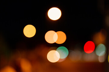 Wall Mural - Bokeh traffic light at night in the street of a big city for background