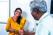 Happy smiling daughter with recovered father talking each other at hospital ward - concept of relationship, communication and treatment.