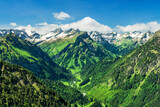 Fototapeta  - Alpine landscape with snowy mountains and green valley at a beautiful summer day. Allgau Alps, Bavaria, Germany, Europe
