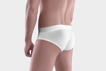 Mockup of white men's panties with a wide elastic band on the guy's shaved body, close-up, underpants isolated on the background, back, side.