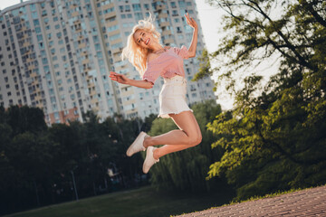 Poster - Full body portrait of cheerful pretty lady jump have fun enjoy pastime street outside