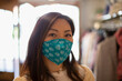© Caia Image - Portrait confident woman wearing face mask in shop