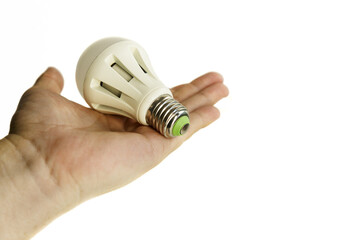 light bulb in hand. The LED light bulb lies in a man's hand. White background