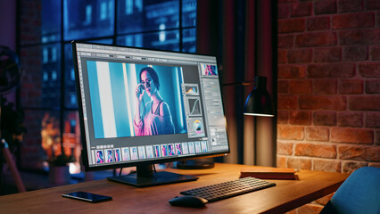 Poster - Modern Loft Office with Night City View From Big Window. Computer Monitor with Opened Editing Softwear Standing on The Work Desk of the Designer. New Type Business Employee Left For Lunch.
