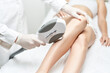 © Anastasia - Woman having hair removal procedure of legs by cosmetologist. Laser hair removal. Cosmetology and spa concept.