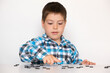 © Zarina Lukash - A 4-year-old boy is learning to count, teaching black numeracy chips for preschoolers