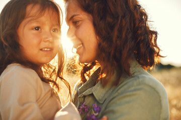 Wall Mural - Mother with daughter playing in a summer field