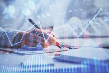 Fototapete - Double exposure of woman's hands making notes with forex graph hologram. Concept stock market analysis.
